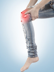 Female having sprain problems, holding her painful leg.