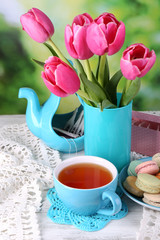 Fototapeta na wymiar Composition of spring flowers, tea and cookies