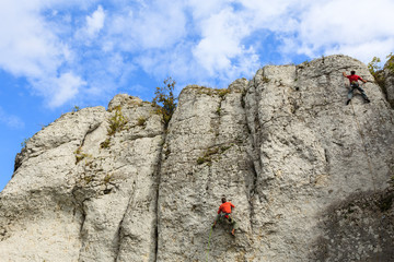 Rock climber on limestone rock near Krakow, Poland