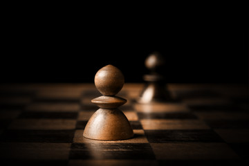 Chess. White and black pawn on chessboard.