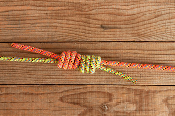 Junction between two mountain ropes on wooden background