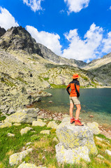 Woman tourist standing on rock in Tatra Mountains, Slovakia