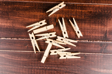 Wooden clothespins on wooden background