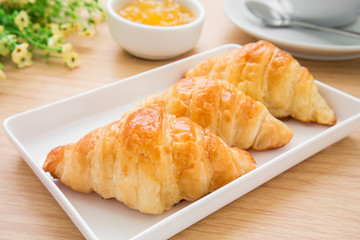Croissants with jam and coffee cup
