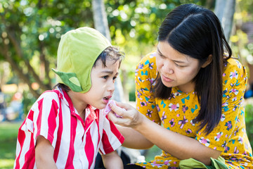 Little boy Bleeding at the mouth and mother help first aid to hi
