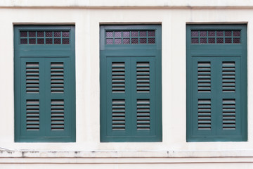 Green old vintage wooden window on white wall