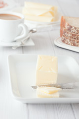 stick of butter on white plate