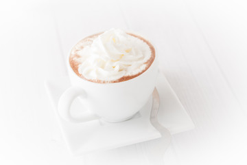 a cup of coffee with wheap cream, isolated, vignetted