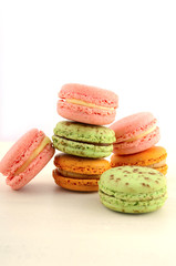 Colorful macaroons on white wood table.