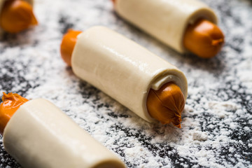 Preparing croissant sausage roll