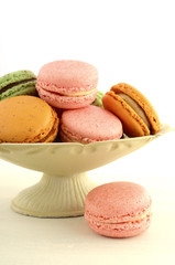 Colorful macaroons on white wood table.
