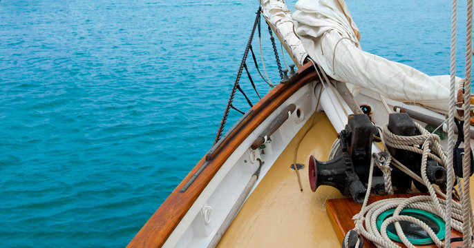 Vintage yacht heading out to sea. Copy space