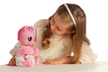 girl playing with her toy pony - 80112446