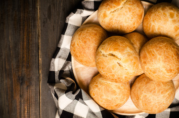 Homemade buns on wooden plate and beautiful fabric