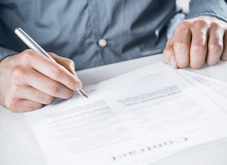 Businessman signing a legal document