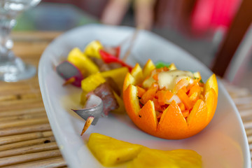 orange and pineapple appetizer served on plate in restaurant or