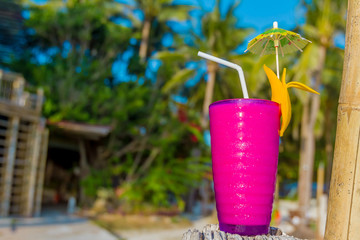 tropical shake, refreshment drink in decorated galss on tropical