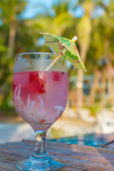 tropical shake, refreshment drink in decorated galss on tropical