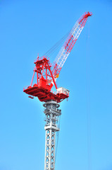 Construction tower crane against blue sky