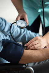 Senior having measured blood pressure