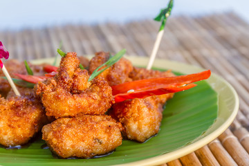 chicken fried in honey sauce, meat ball served on palm tree leaf