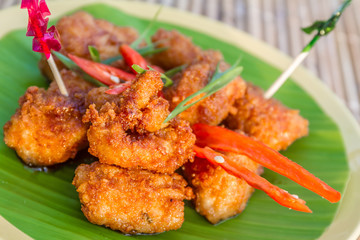 chicken fried in honey sauce, meat ball served on palm tree leaf