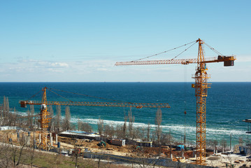 Construction site with cranes near the sea