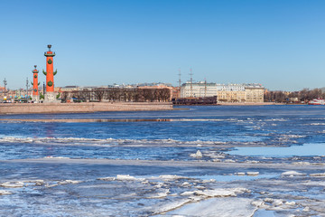 Rostral columns and floating ice on Neva river in Petersburg
