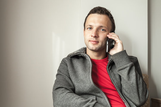 Portrait of young adult man talking on mobile phone