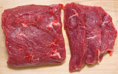 Uncooked beef on a wooden board