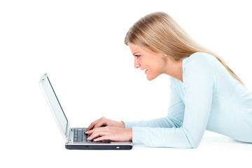 Naklejka premium Blonde girl working on laptop, white background