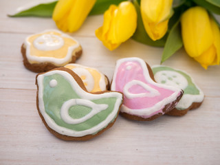 Easter bird and flower shaped cookies and yellow tulips