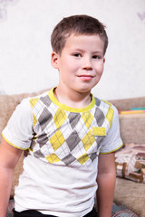 Smiling Caucasian preschool boy portrait, looking at camera