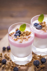 Delicious dessert, flakes flooded in two flavors yogurt with blu