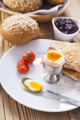 Soft-boiled egg in the morning with pepper, tomatoes and crouton