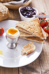 Soft-boiled egg in the morning with pepper, tomatoes and crouton