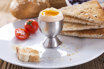 Soft-boiled egg in the morning with pepper, tomatoes and crouton