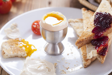 Soft-boiled egg in the morning with pepper, tomatoes and crouton