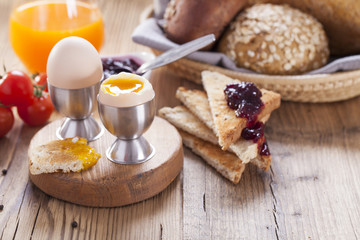 Soft-boiled egg in the morning with pepper, tomatoes and crouton