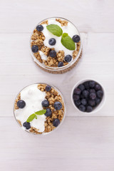 Delicious dessert, flakes flooded in two flavors yogurt with blu