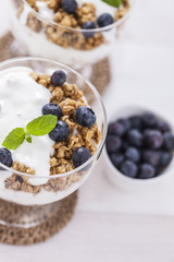 Delicious dessert, flakes flooded in two flavors yogurt with blu