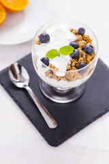 Delicious dessert, flakes flooded in two flavors yogurt with blu