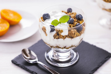 Delicious dessert, flakes flooded in two flavors yogurt with blu