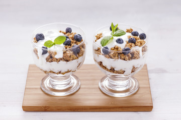 Delicious dessert, flakes flooded in two flavors yogurt with blu