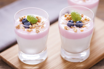 Delicious dessert, flakes flooded in two flavors yogurt with blu