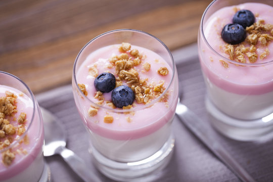 Delicious dessert, flakes flooded in two flavors yogurt with blu