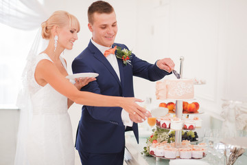 the bride and groom cut the cake