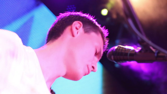 vocalist sings his part (close-up, bottom view from left side)