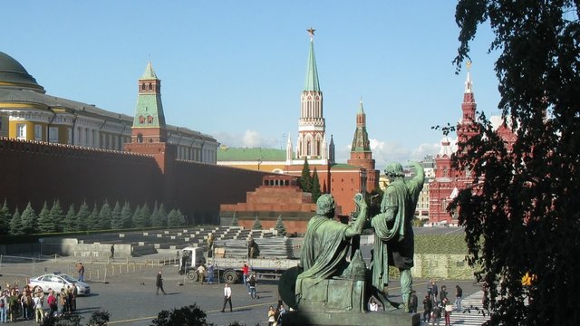 Tourists walk near monument to Minin and Pozharsky
