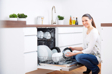 20s woman in kitchen, empty out the dishwasher 2